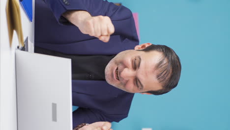 Vertical-video-of-Happy-businessman-getting-good-results-on-laptop.